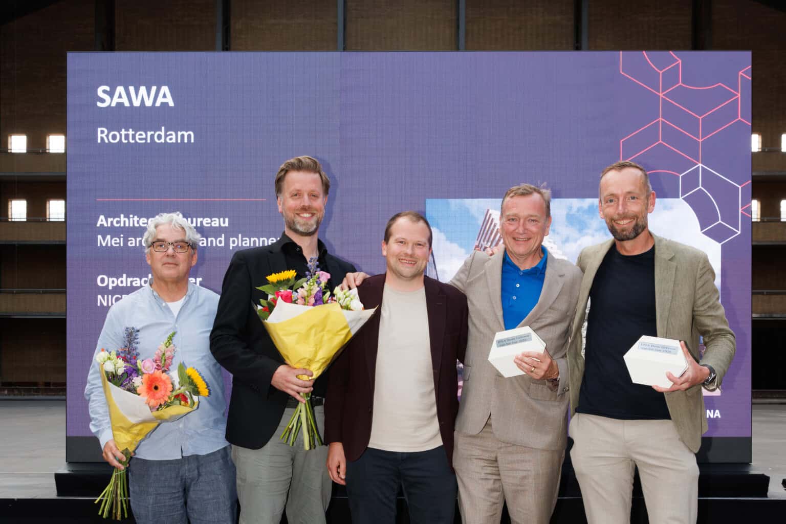 The winning SAWA team on stage. From left to right: Leen Kooman, Joost Wetzel, Michiel van Loon and Robert Winkel of Mei architects and planners, and Mark Compeer of NICE Developers. Photo: Bas van Hattum