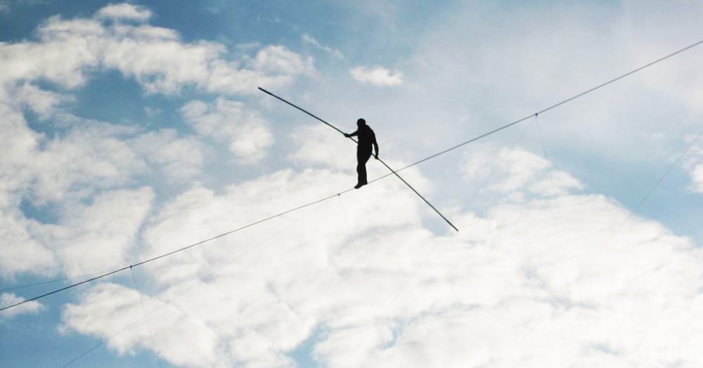 Man walking tightrope